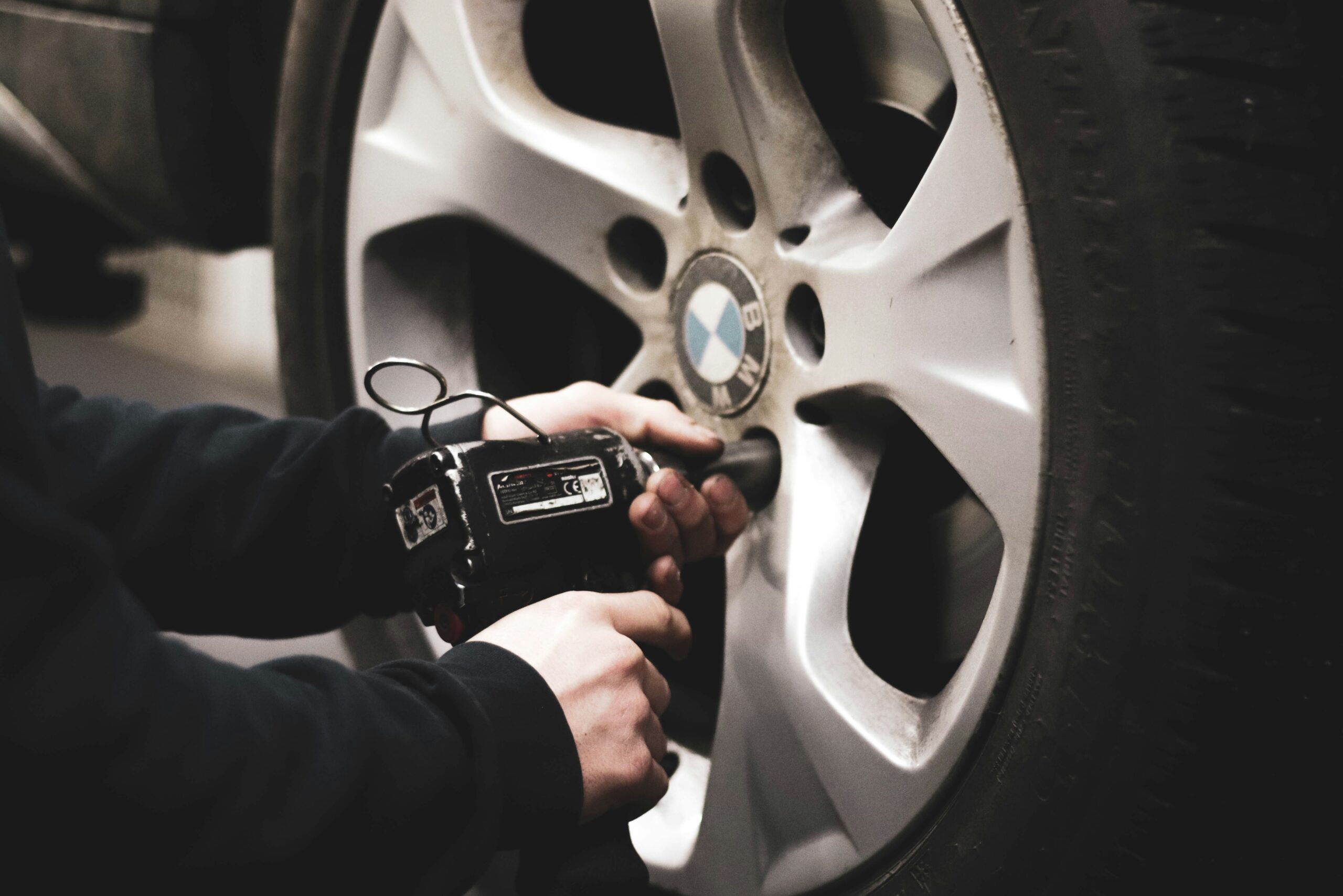 A mechanic unscrewing bolts in a BMW car