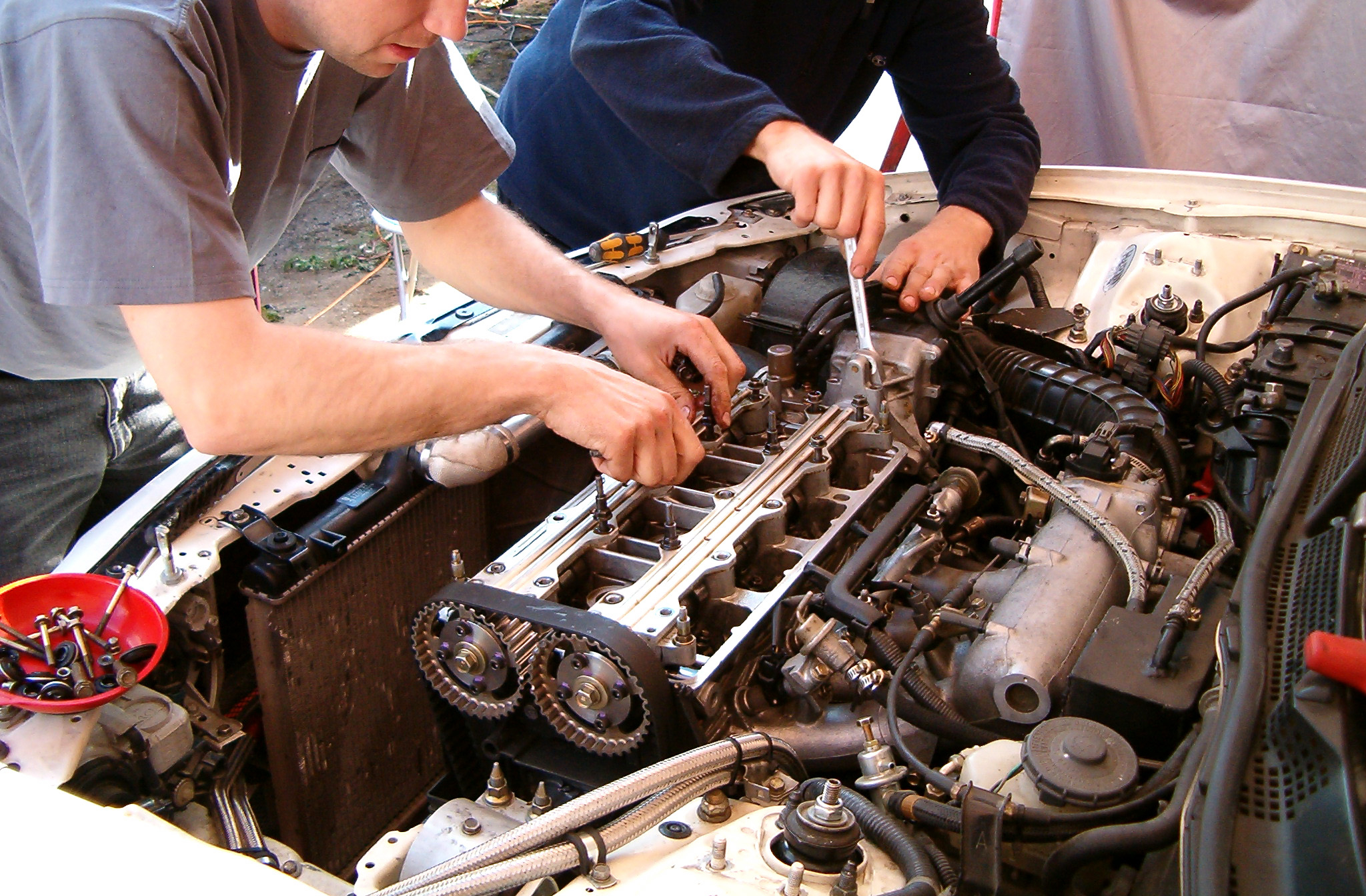Two mechanics doing regeneration services on a diesel engine
